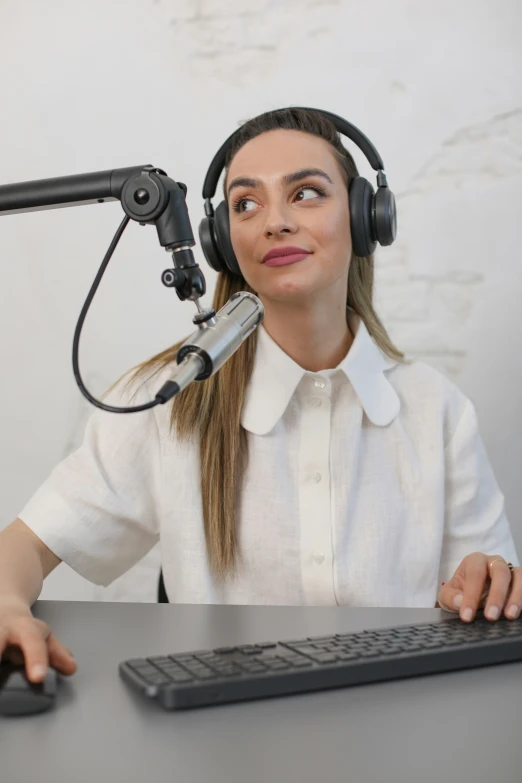 there is a female with headphones on in front of a microphone