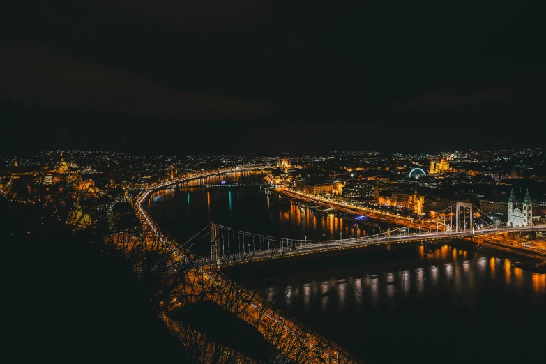 night time scene with view of a city bridge over water