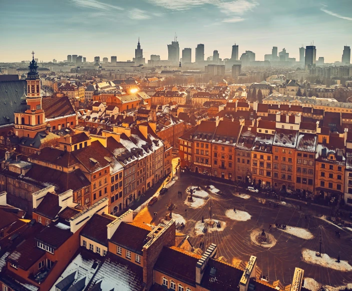 a large city with brown brick buildings at sunset