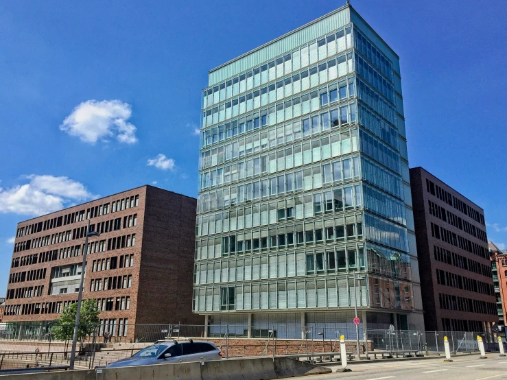 the tall building has many windows next to a parking lot