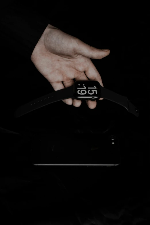 a person holding onto a black object in their hand