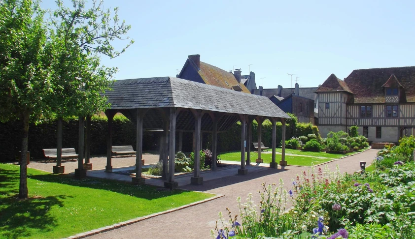 a gazebo with several benches in a garden