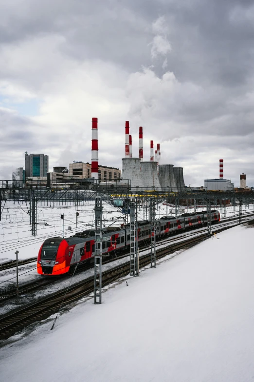 a train is traveling down the tracks in the snow