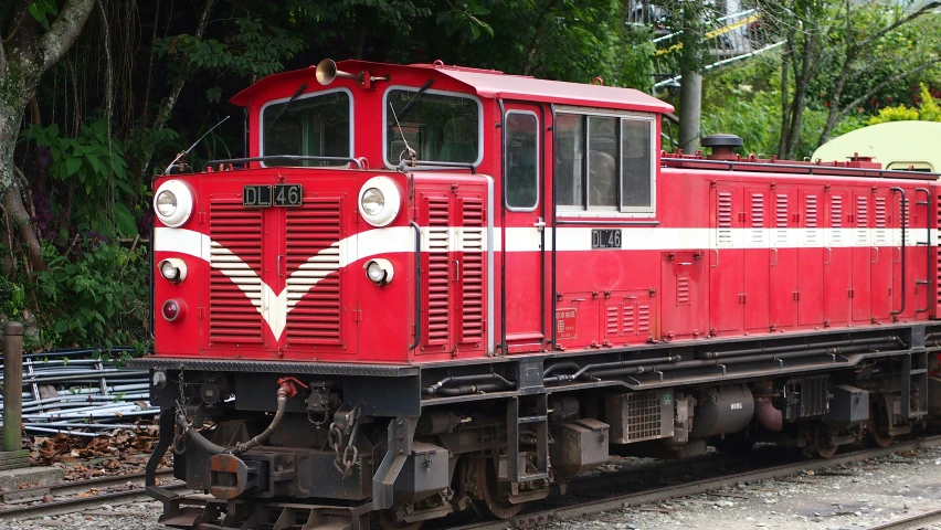 an old red train traveling down train tracks