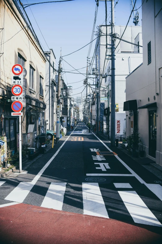 a street scene in an urban area with power lines above