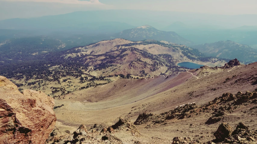 a mountain view with several steep peaks and blue water