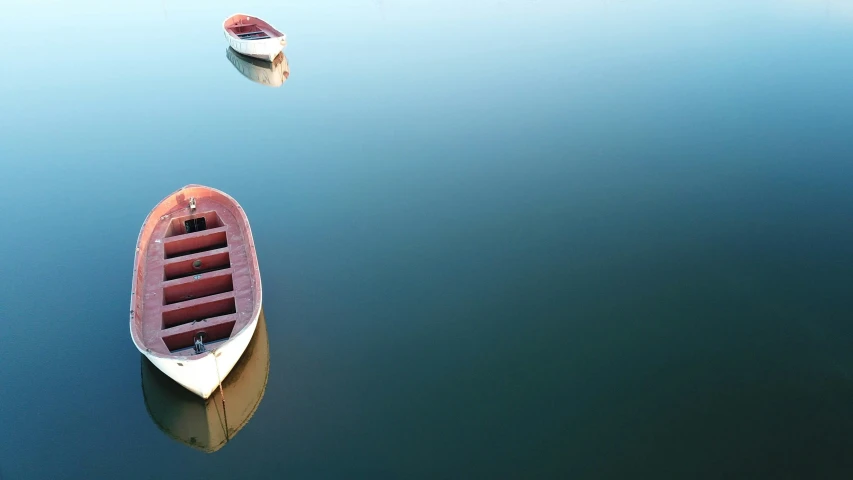 two boats sit in a body of water
