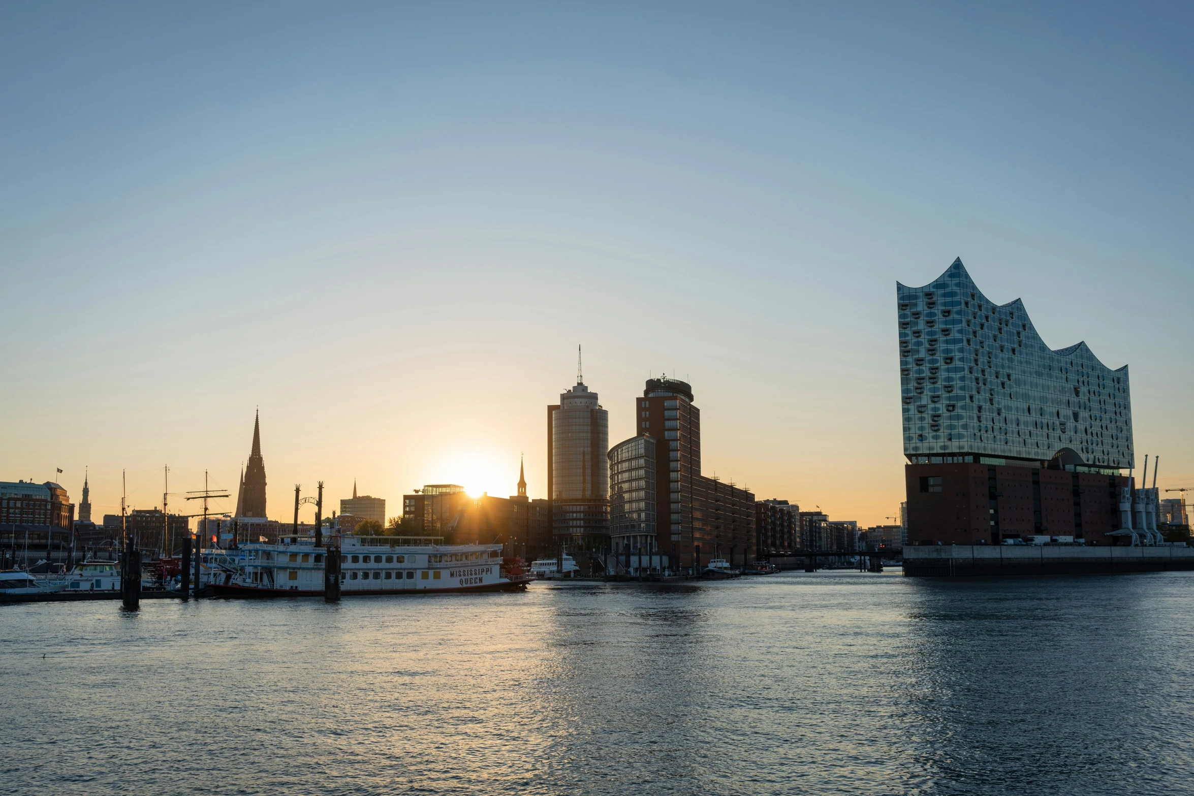 sunset with buildings in the background and harbor in front