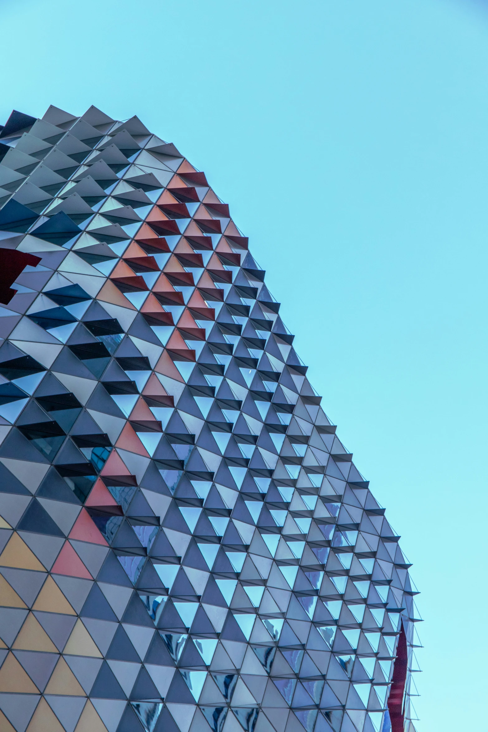 a very modern building with triangular shapes on the top