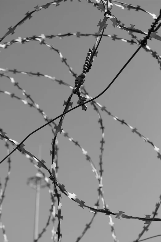 a barbed wire fence, a phone booth and the sky