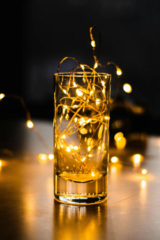 an iced glass filled with candles on top of a table