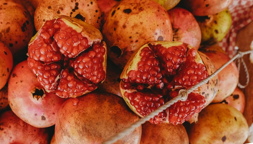 pomegranate still attached to pieces of fruit