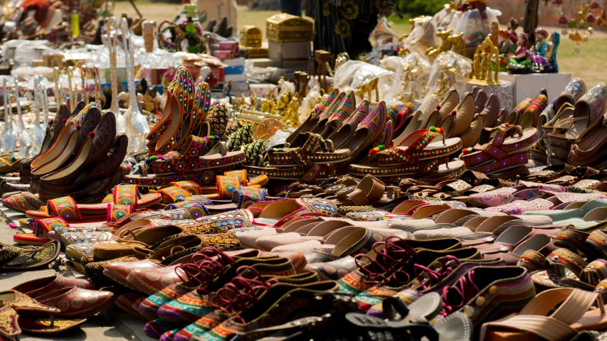 many pairs of shoes are laid out on display