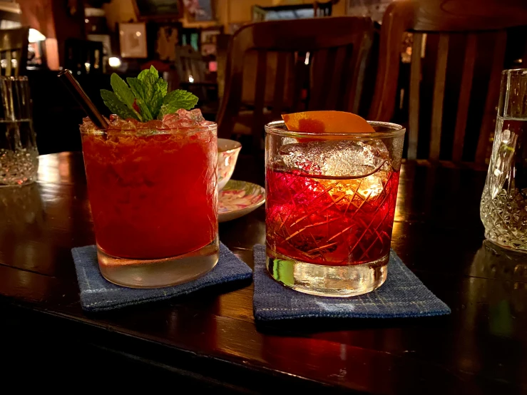 three drinks on a table in a bar