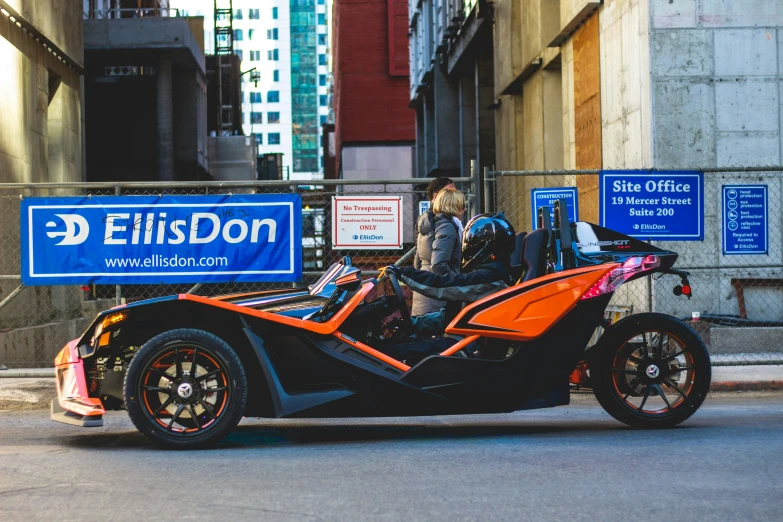 an electric vehicle with three wheels on a city street