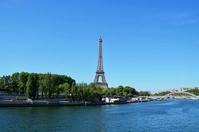 the eiffel tower is visible above the water