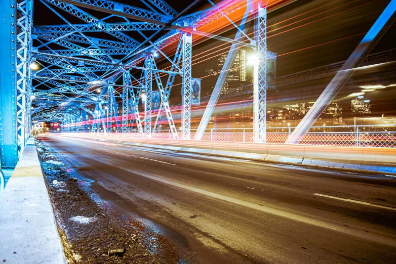 blurry pograph of an interstate overpass and a city skyline at night