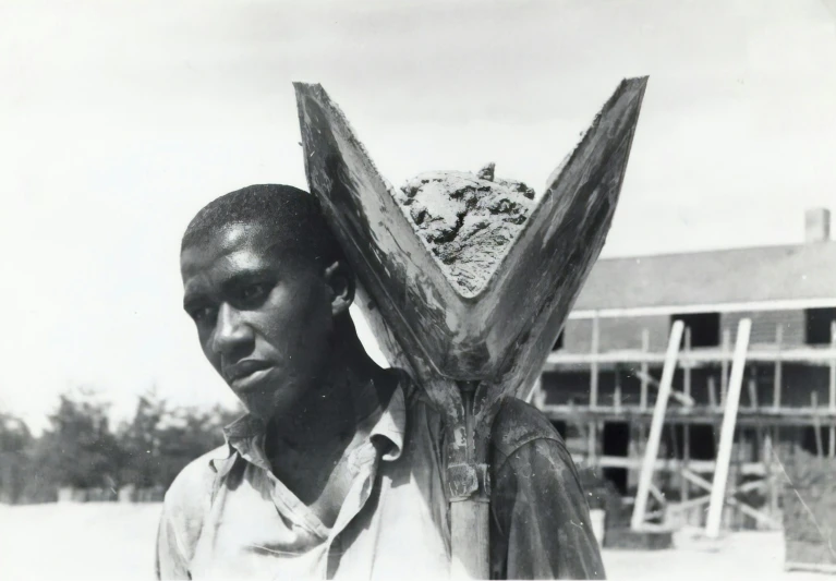 the man is holding onto a wooden structure