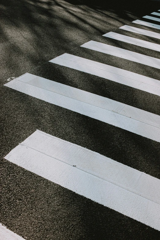 there are some black and white street signs on the crosswalk