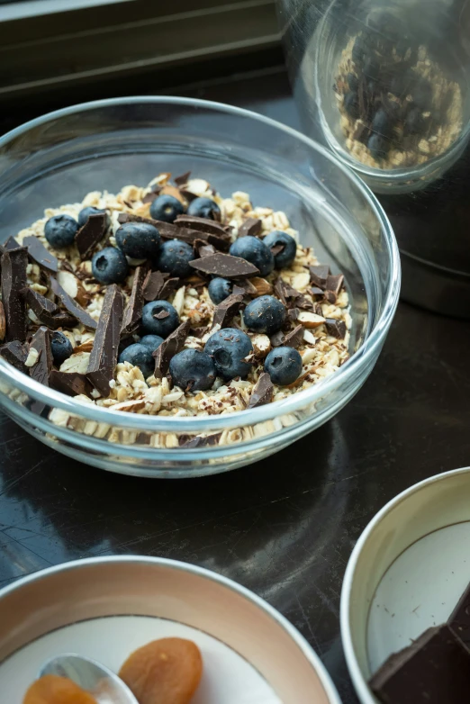 blueberries and granola sitting in a bowl on a counter