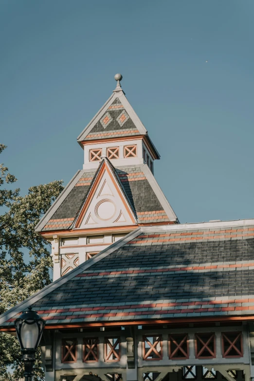 an old church with a weather vein and clock