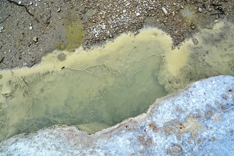 a muddy looking area with some snow and mud on it