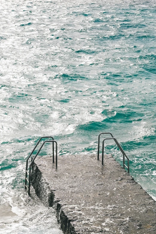 an old pier with steps leading into the water