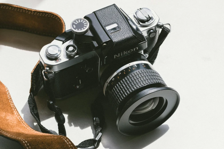 an old fashioned black camera sitting on the floor