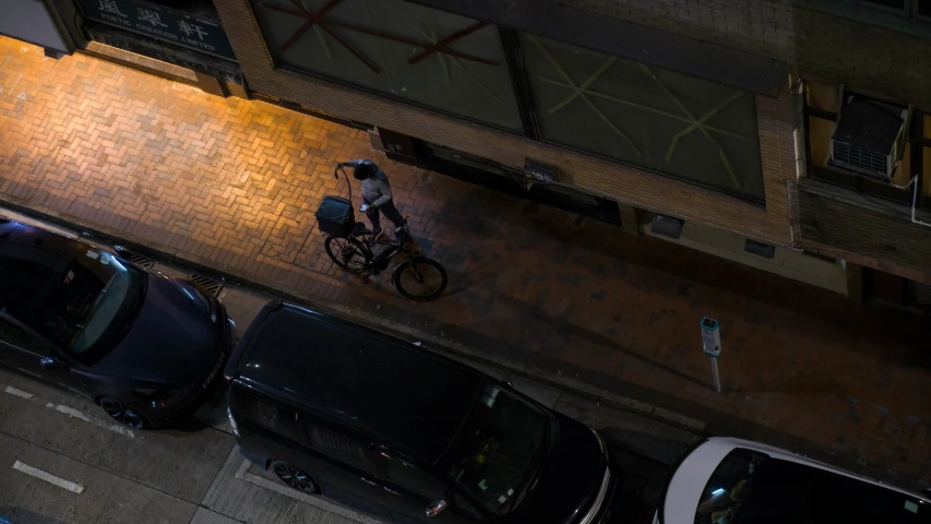 there is a bicyclist on the street at night