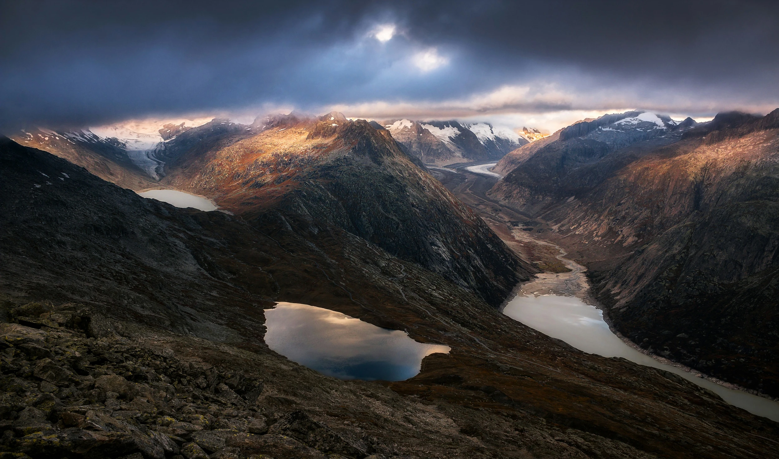 a mountain view of a lake surrounded by mountains