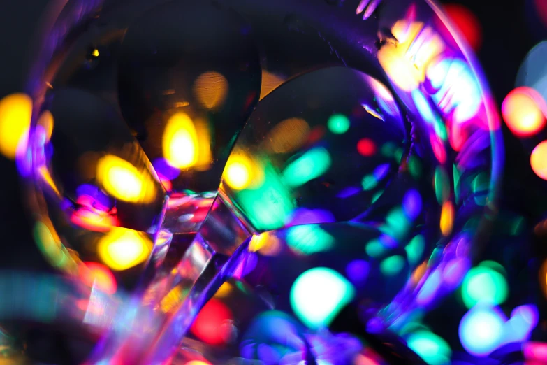 colorful blurry lights surrounding an object with a black background