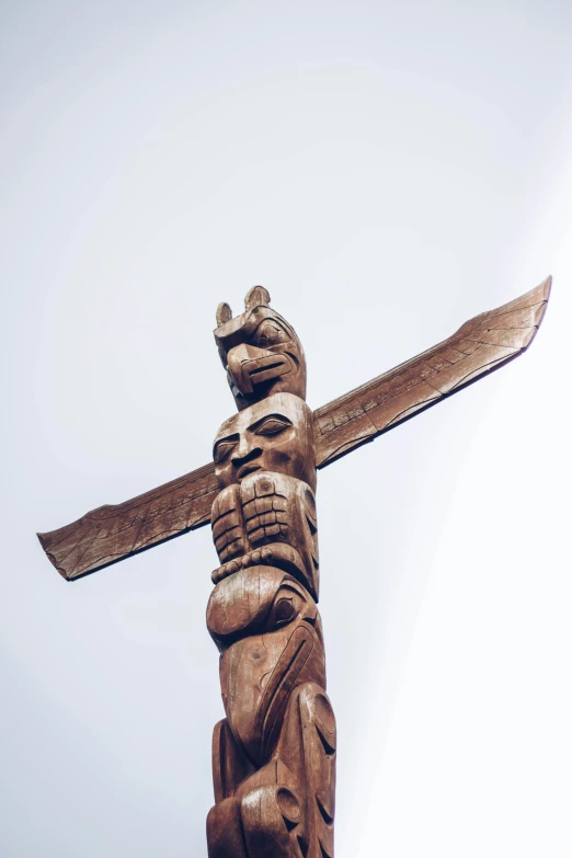 a carved wooden figure stands atop an altar