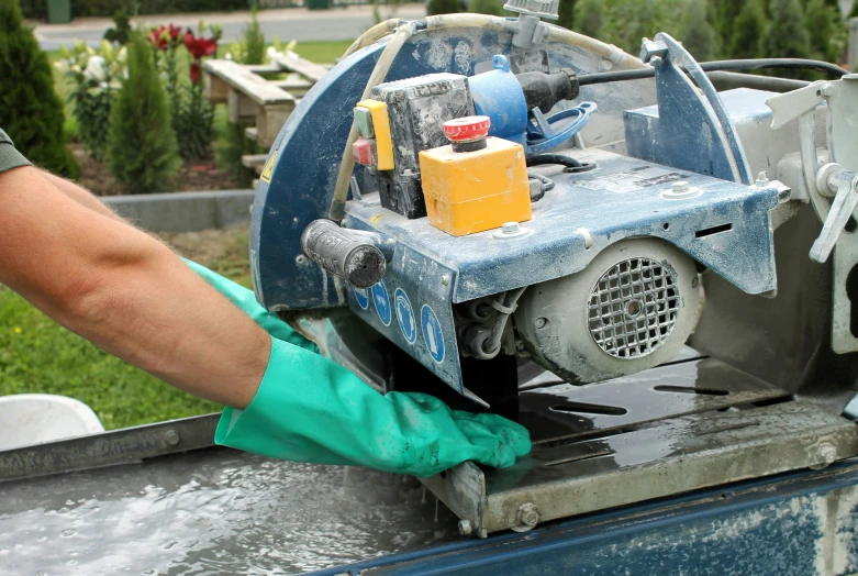 a man washing a car with a high pressure washer