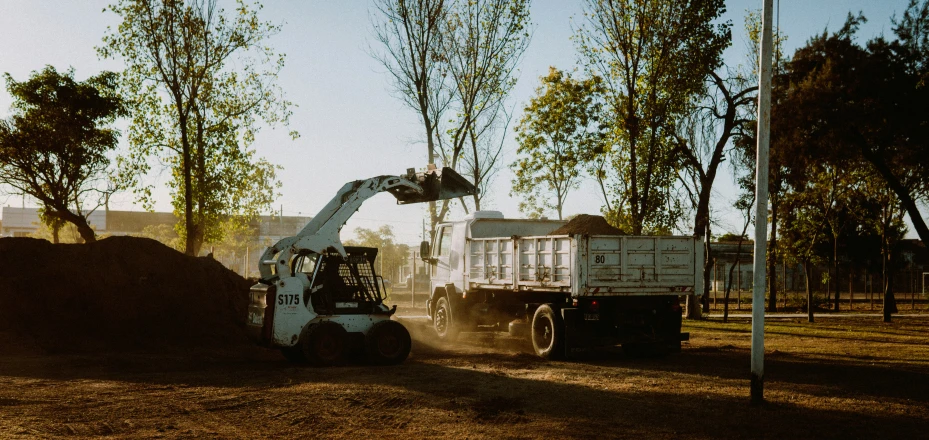 a large truck with a pile of wood behind it