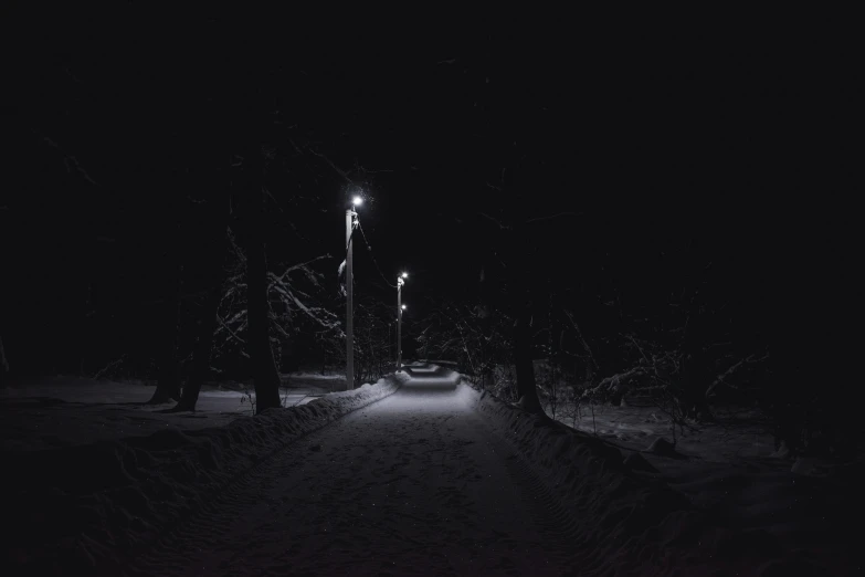 an image of a street with headlights in the dark