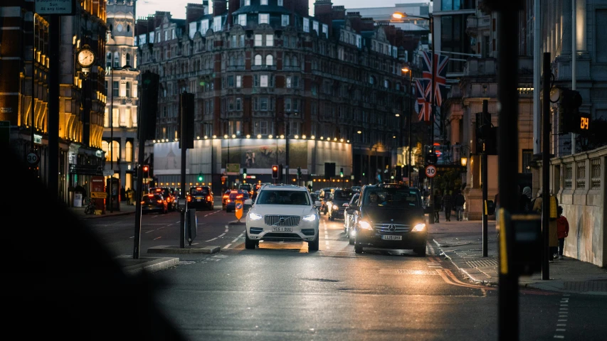 a city street with cars and people driving