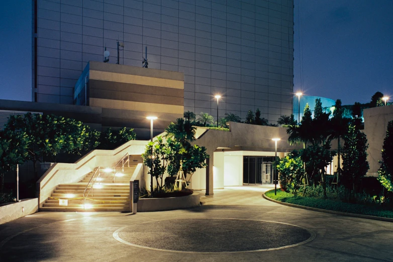 an empty parking area with a circular planter at night