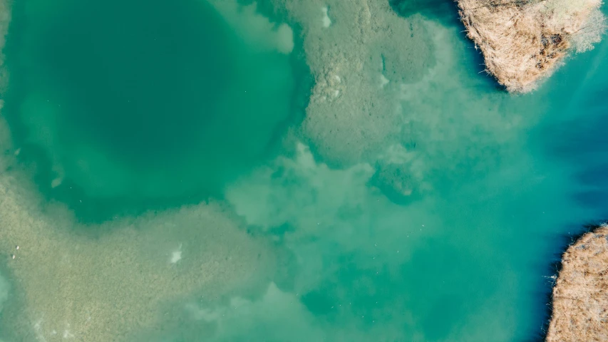 some blue and green water with rock outcroppings