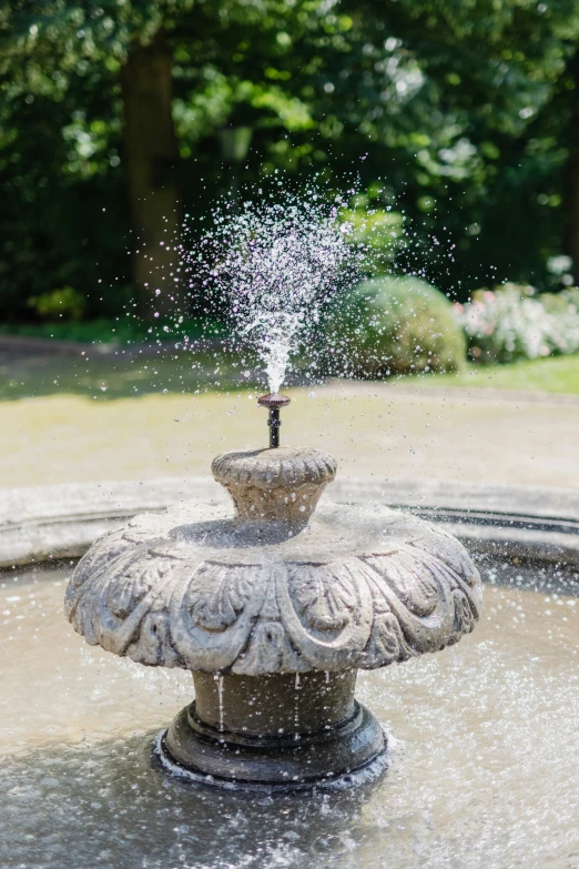 water spews out of a cement fountain