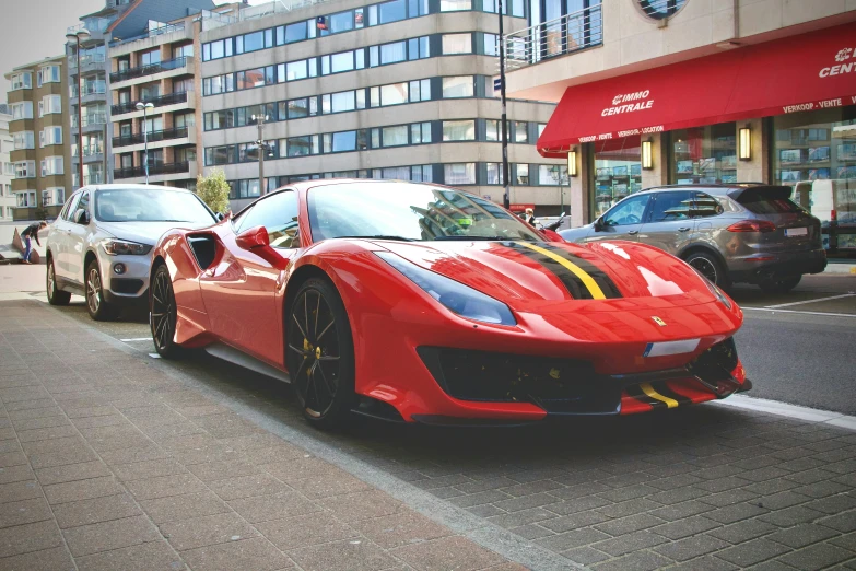 a red sports car in the street during the day