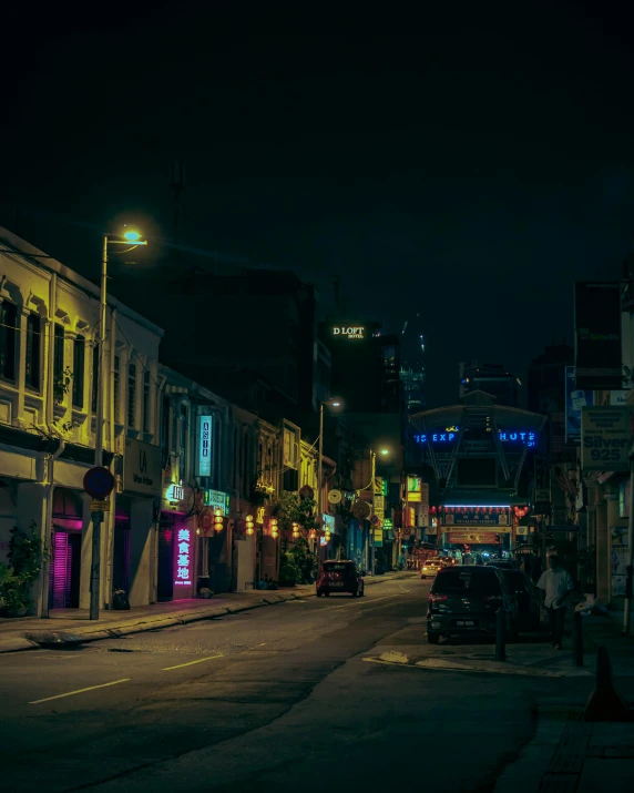 a city street with colorful lights on the buildings