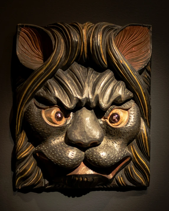 a mask of a wolf with yellow eyes in a wall