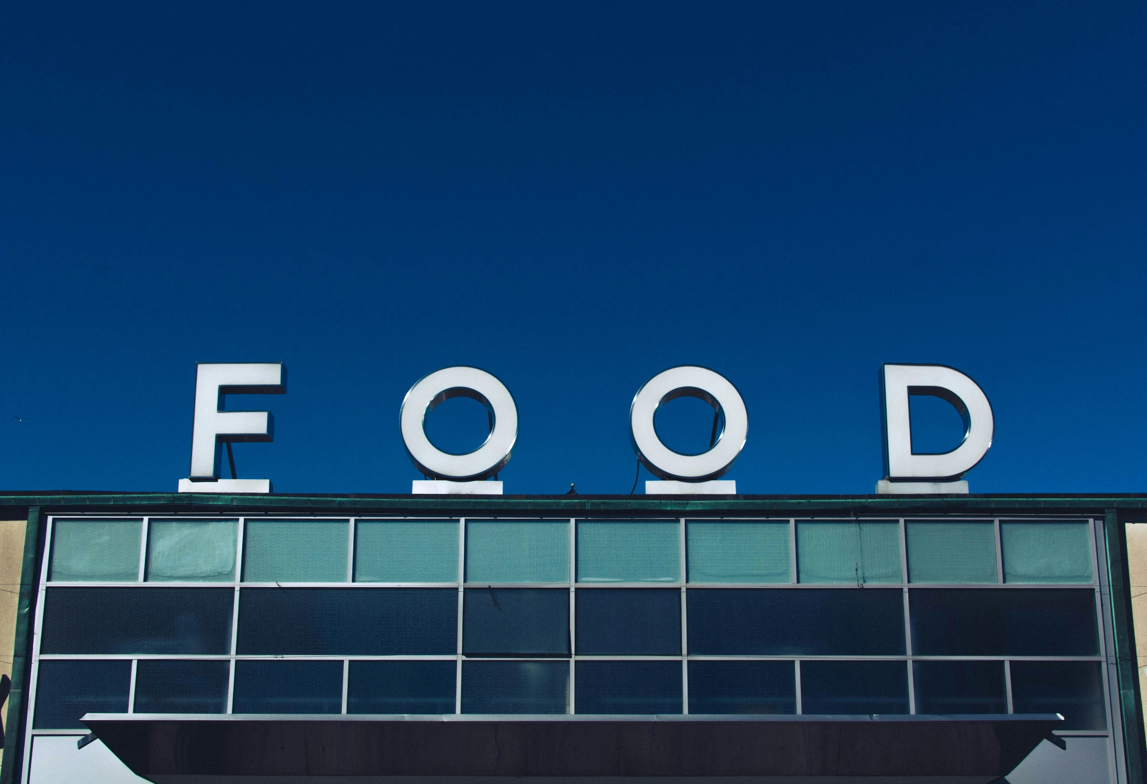 a view from below a very large building that reads food