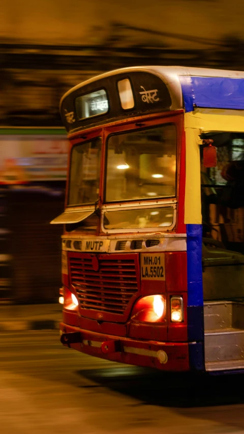 a big colorful bus with some people behind it