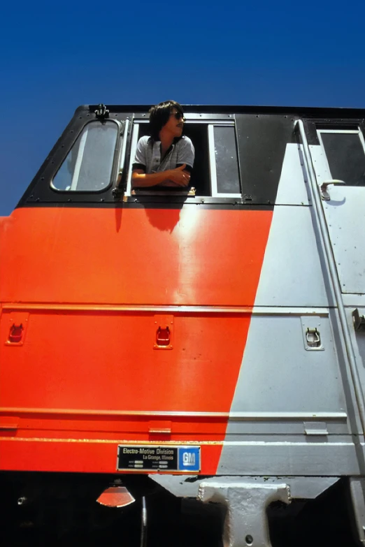 a man riding in the top of a train