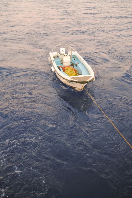 a boat tied to a rope in the water