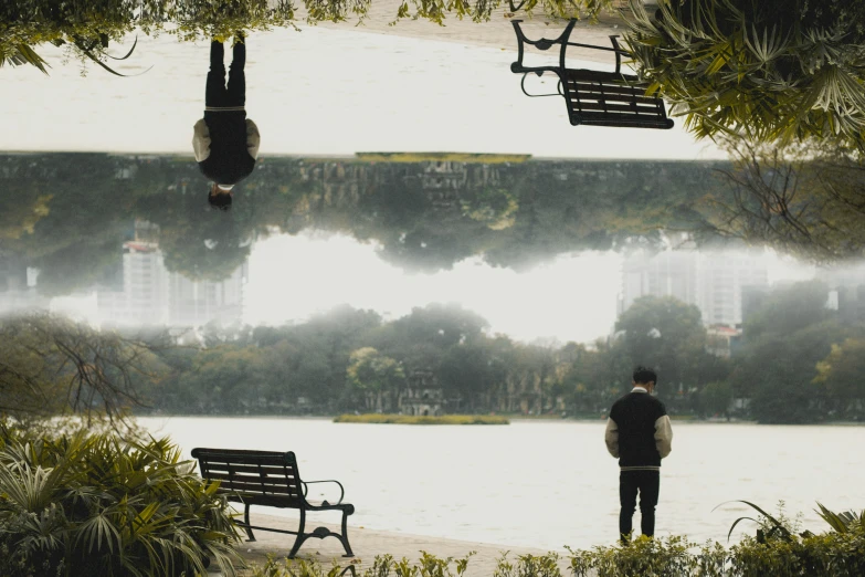 a man stands in front of some empty benches