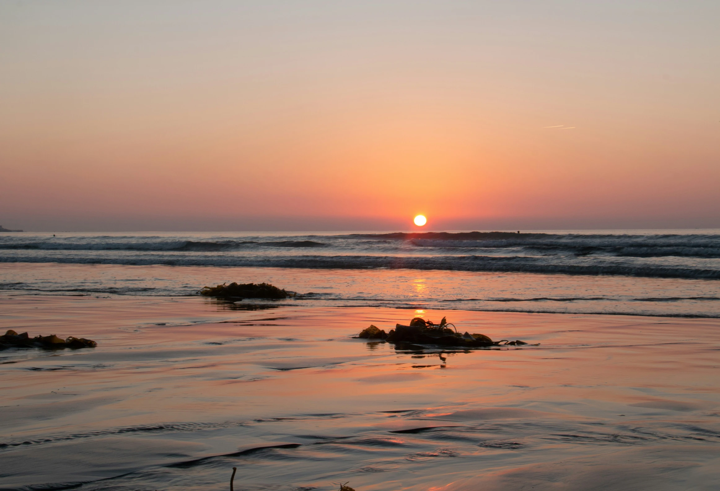 the sunset over the water shows a beautiful setting