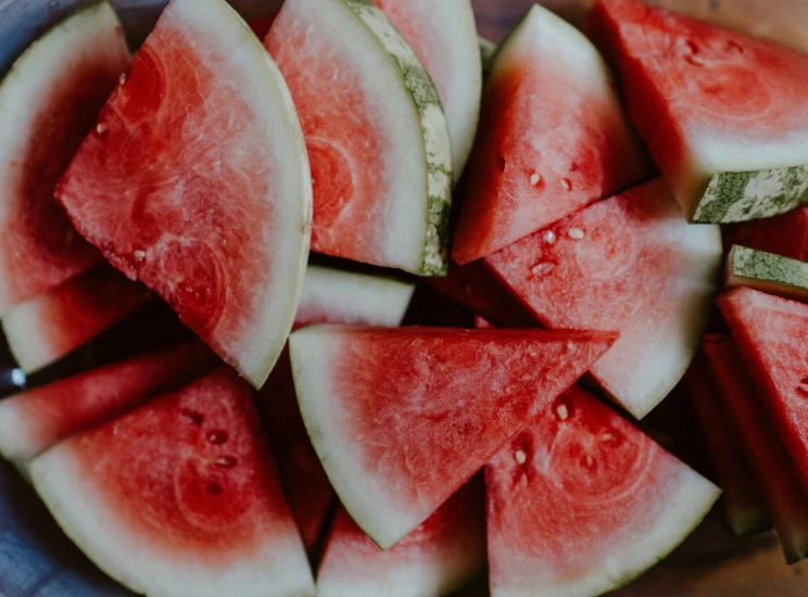 a bowl full of sliced watermelon on top of a table