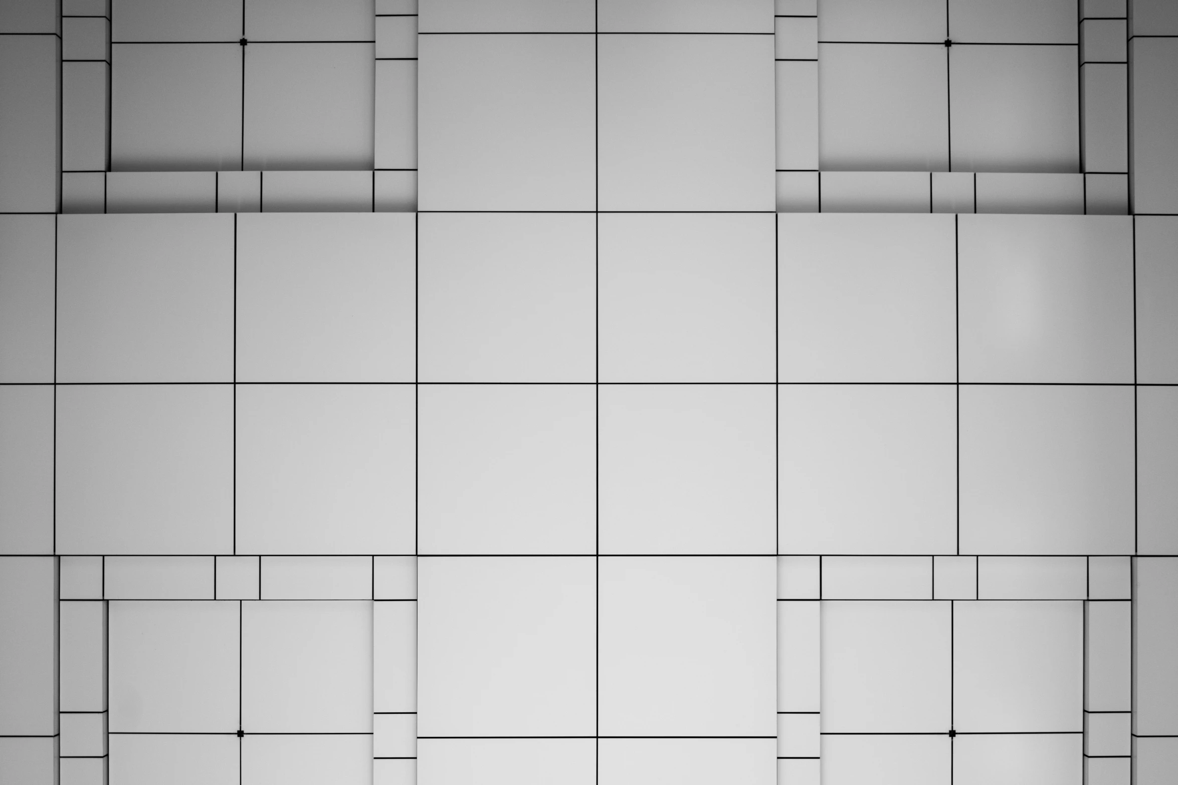 black and white tiles arranged as wall pattern